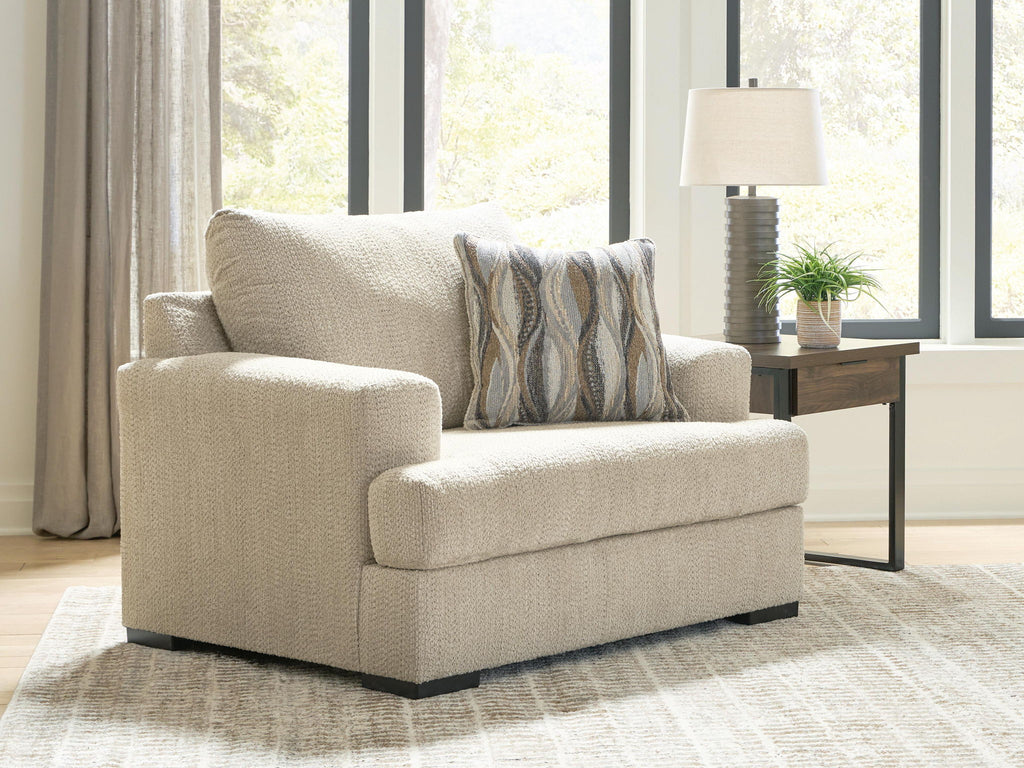 Lofwood chair and a half in beige fabric with patterned back pillow and low black legs