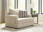 Lofwood chair and a half in beige fabric with patterned back pillow and low black legs