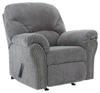 Pewter fabric rocker recliner, padded arms, nailhead trim, and recline footrest
