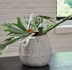 Ceramic vase with green stems, dark interior rim, and speckled light gray ceramic finish
