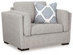Light gray upholstered chair with striped accent pillow on seat