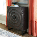 Black accent cabinet with circular radiating metal pattern on the front