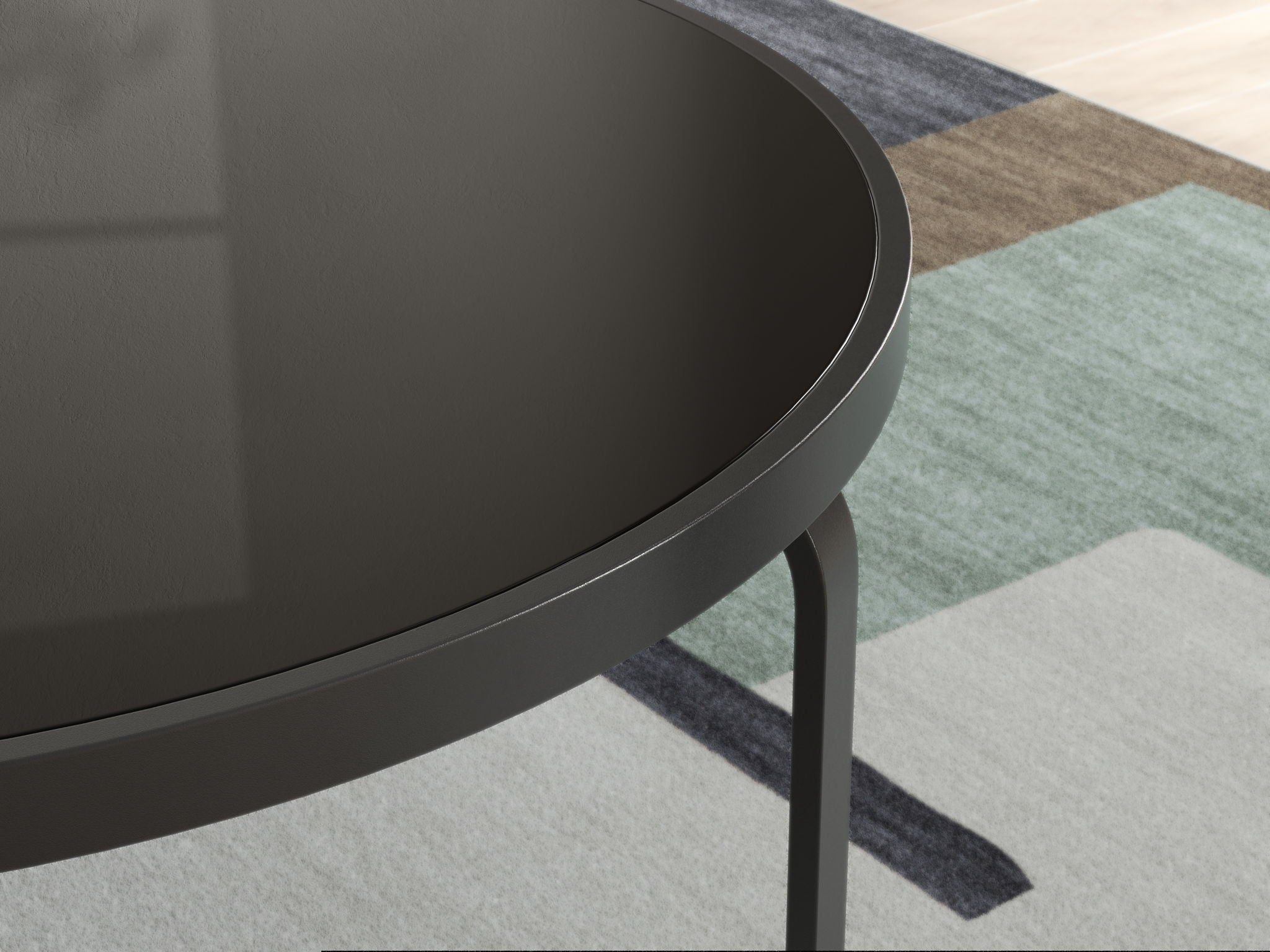 Close-up of black round tabletop edge with curved rim and slender legs
