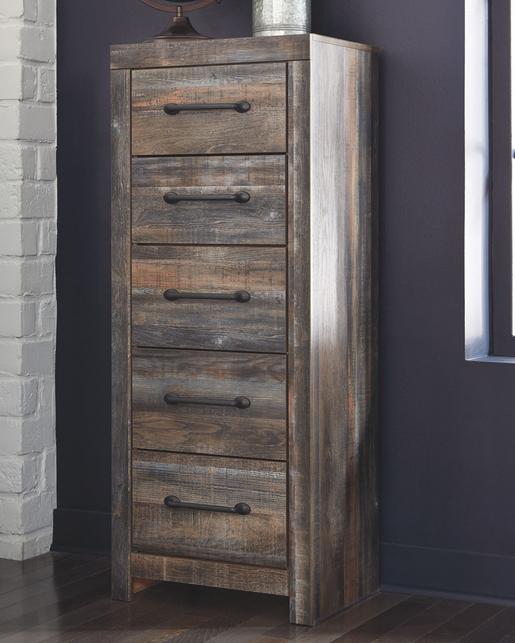 Tall narrow distressed wooden chest of drawers in brown with five drawers and black pulls