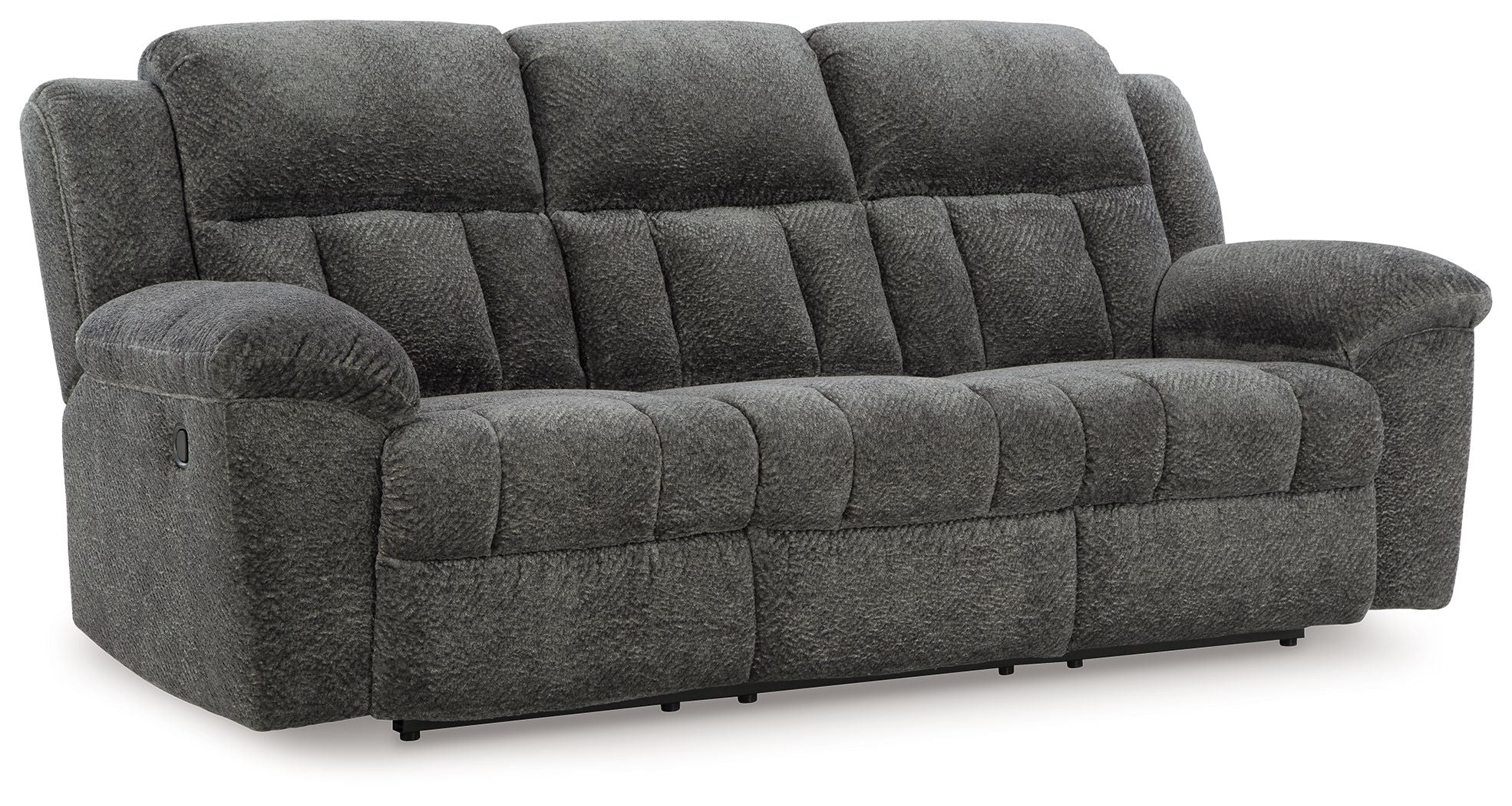 Graphite gray reclining sofa with tufted back, rounded padded arms, and cushioned seat