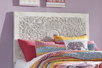 White carved panel headboard with ornate floral scrollwork and circular center medallion