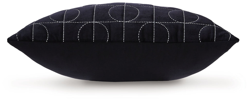 Dark fabric pillow with stitched curved circle pattern and neat piping