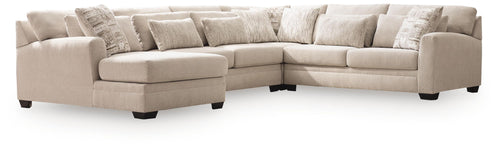 Light beige sectional sofa with chaise corner and tufted seat cushions, patterned throw pillows