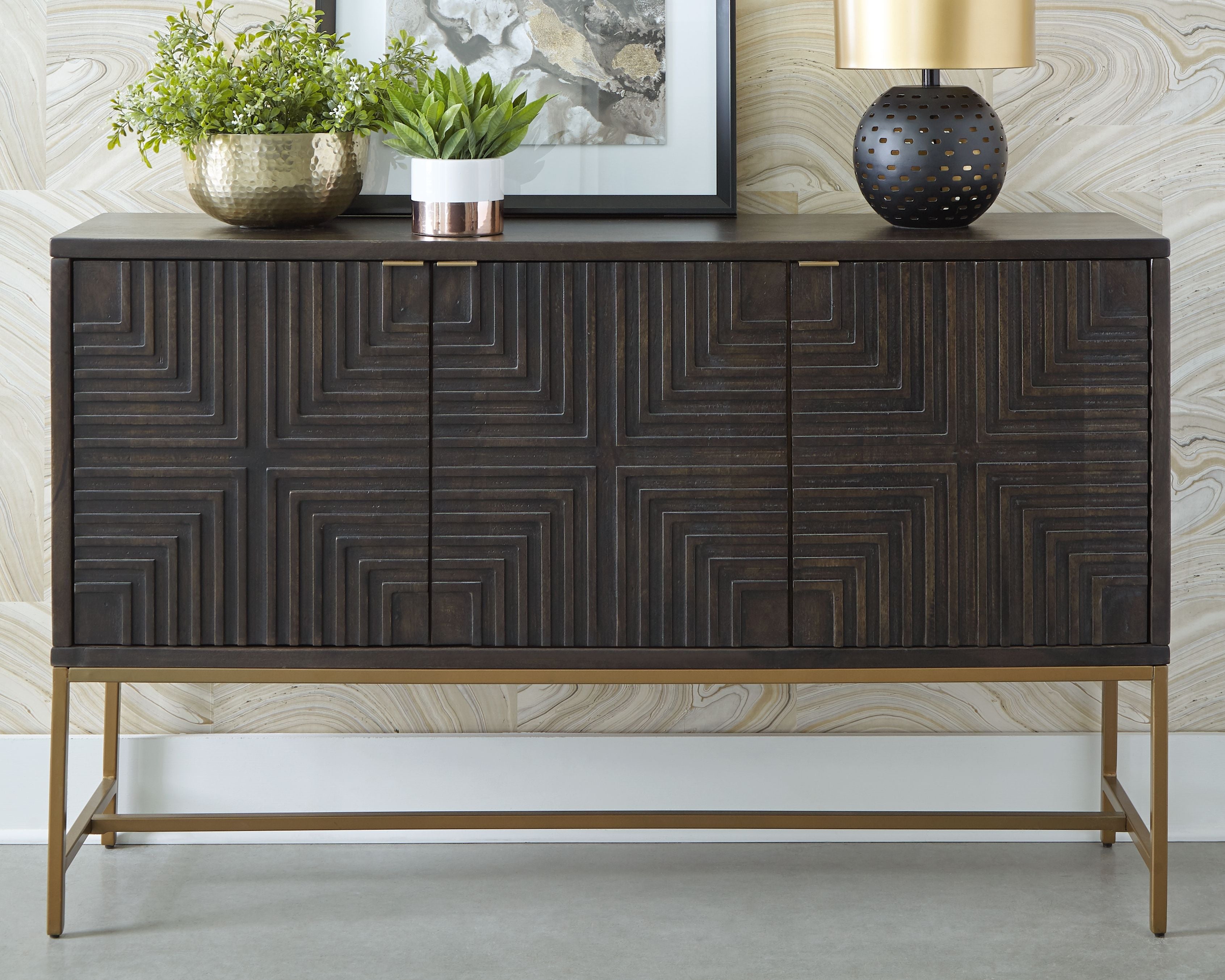 Dark brown accent cabinet with geometric door panels and gold-tone base frame