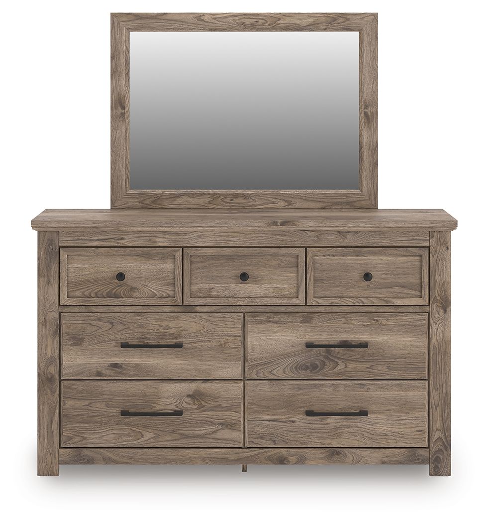 Light brown dresser with mirror and seven drawers with round knobs