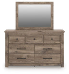Light brown dresser with mirror and seven drawers with round knobs