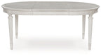 Antique white oval dining extension table shown from the side with center seam