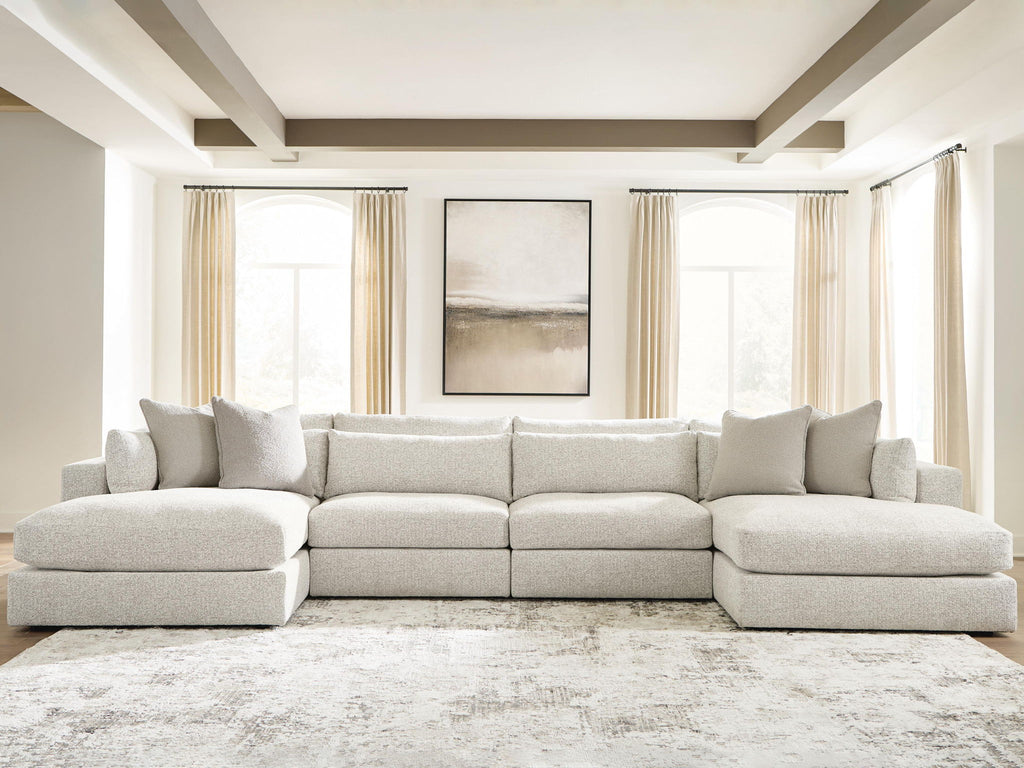 Beige sectional sofa with chaise ends and row of back pillows