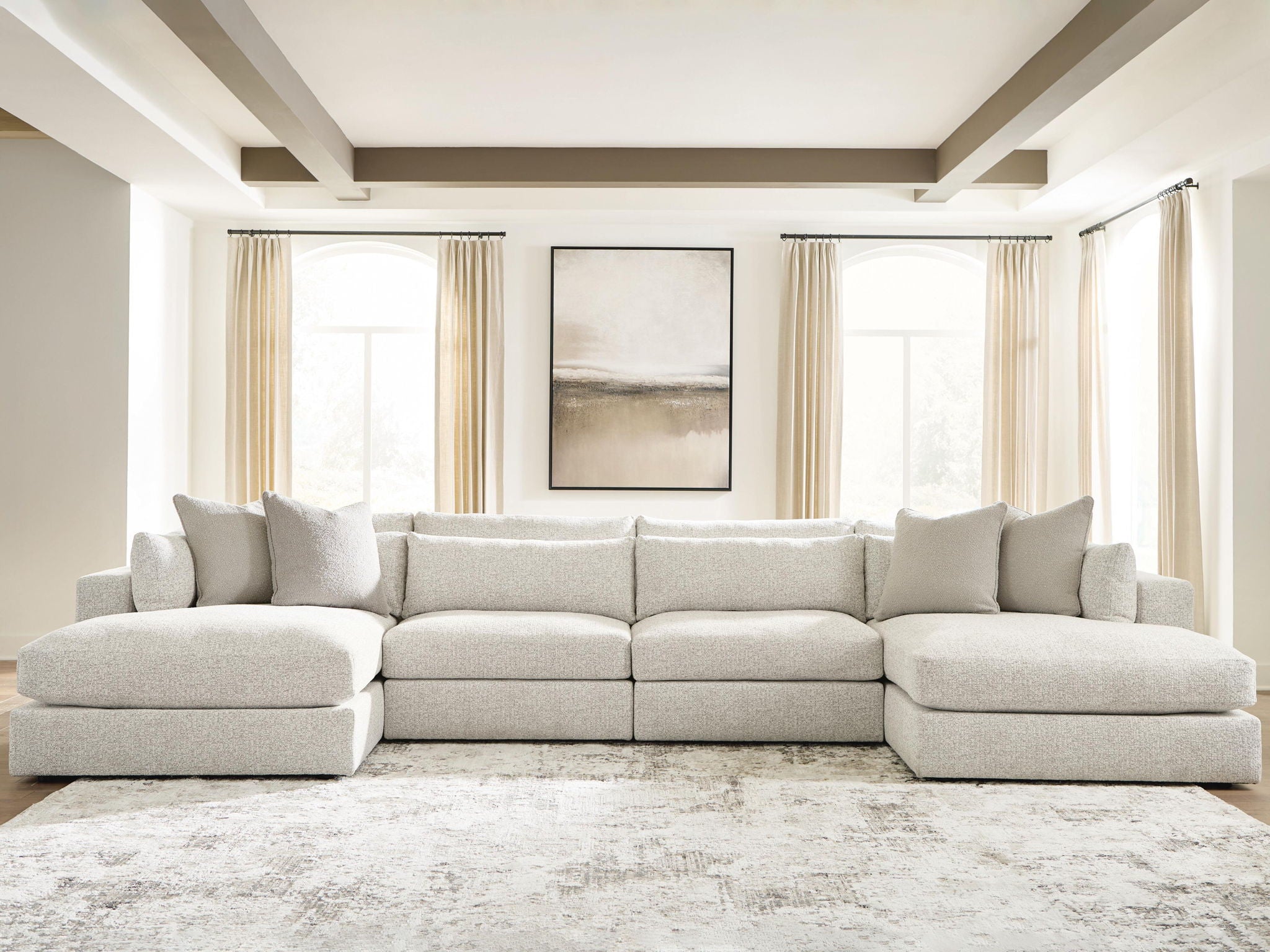 Beige sectional sofa with chaise ends and row of back pillows
