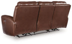 Dark brown power reclining sofa showing reclined footrest and adjustable headrests
