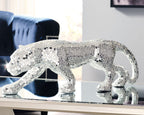 Silver-gray mosaic panther sculpture, side view with arched back and raised tail.
