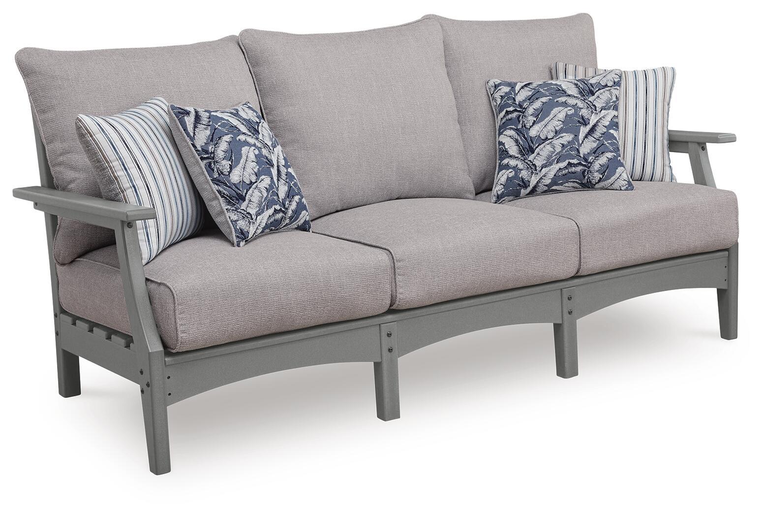 Gray outdoor sofa with cushions and striped floral throw pillows