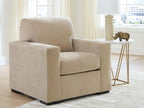 Light beige fabric accent chair with wide arms and cushioned seat, rounded back support.