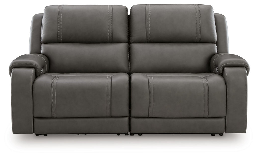 Dark gray power reclining loveseat with two wide seats, padded arms, and button-tufted backs