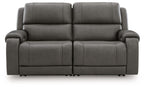 Dark gray power reclining loveseat with two wide seats, padded arms, and button-tufted backs