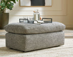 Gray ottoman with textured fabric top and thick upholstered base