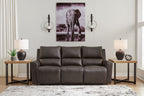 Dark charcoal power reclining sofa with three seat cushions and split back pillows