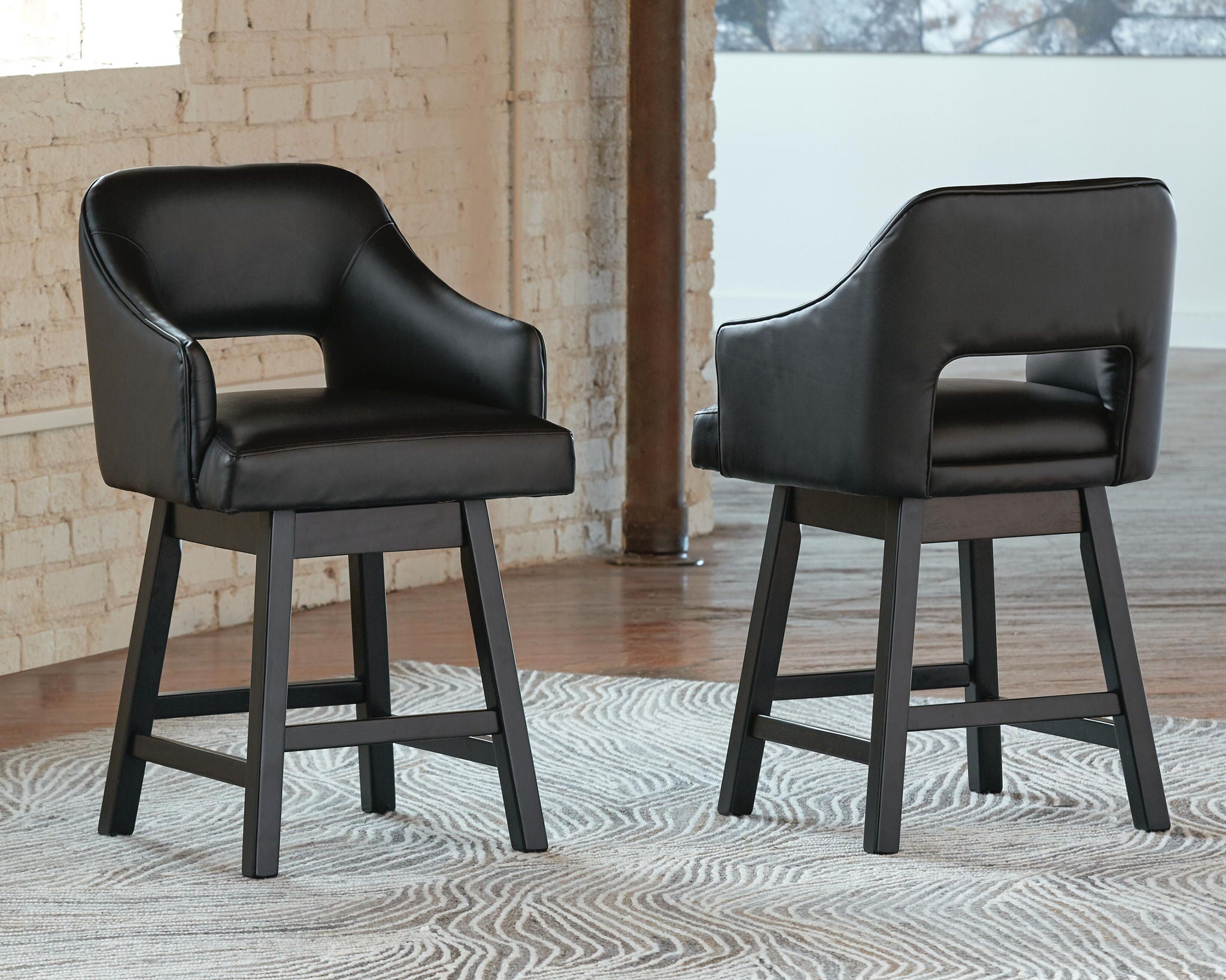 Black upholstered barstools with wide arms and curved back, with footrest rails, set of 2