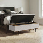 Stone upholstered storage bench with open lid and dark metal lift supports