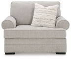 Light gray chair and a half with two rounded arms and striped throw pillow