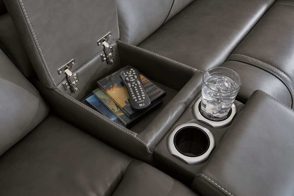 Dark gray reclining sofa console with storage compartments, remote, and cup holder