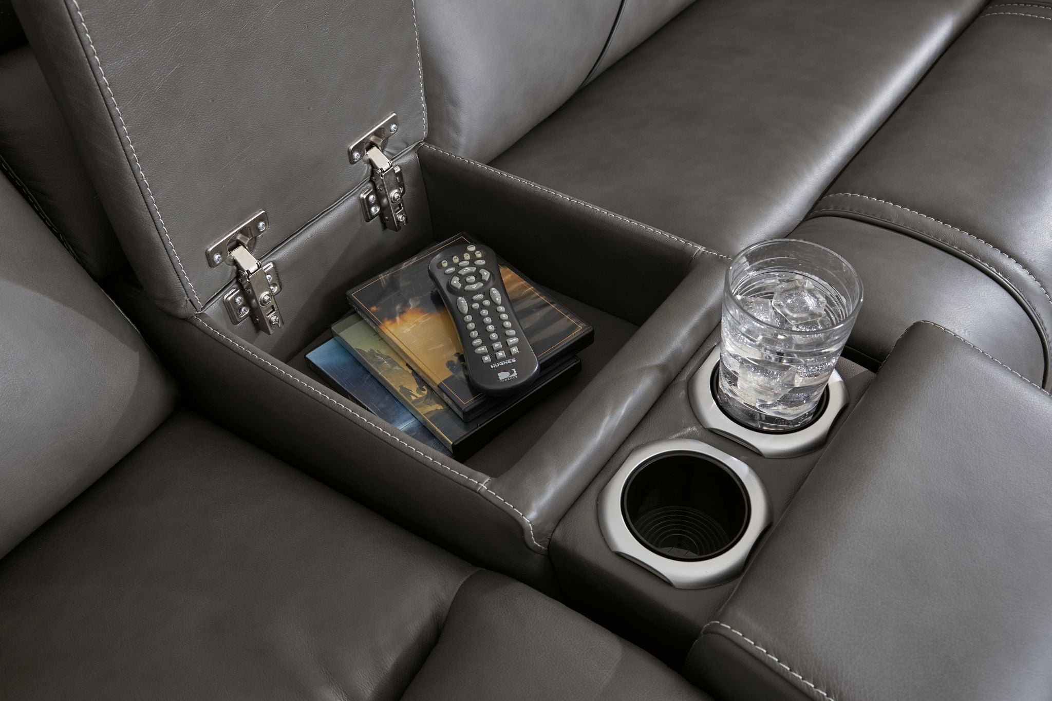 Dark gray reclining sofa console with storage compartments, remote, and cup holder