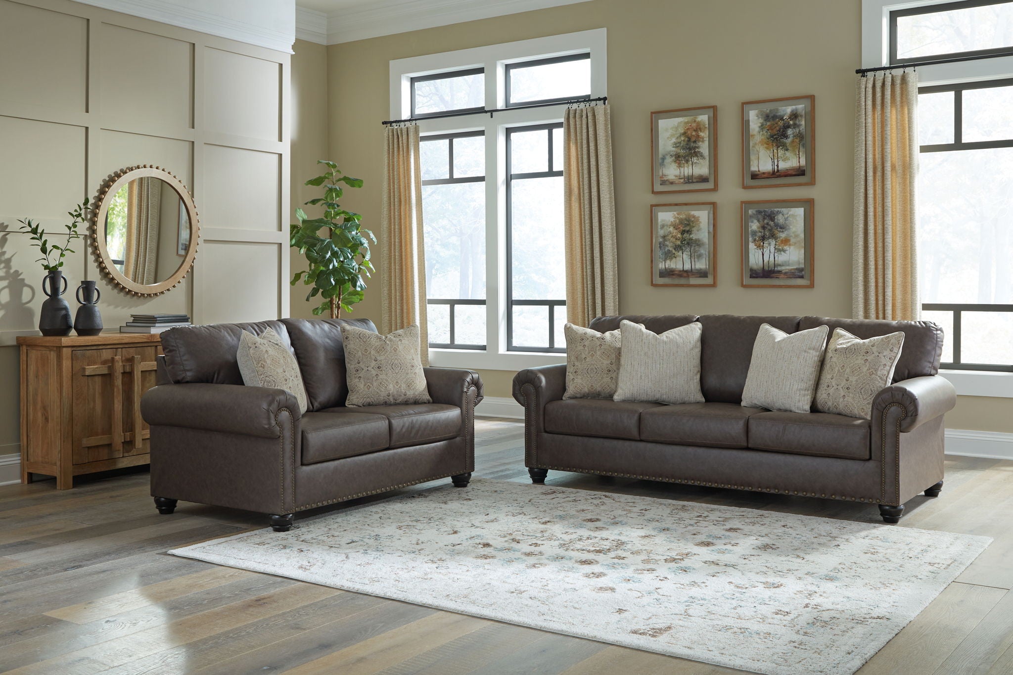 Dark brown upholstered living room seating set with two chairs and a sofa.