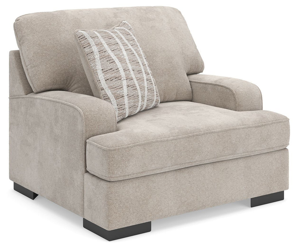 Taupe upholstered chair and a half with striped accent pillow and dark legs