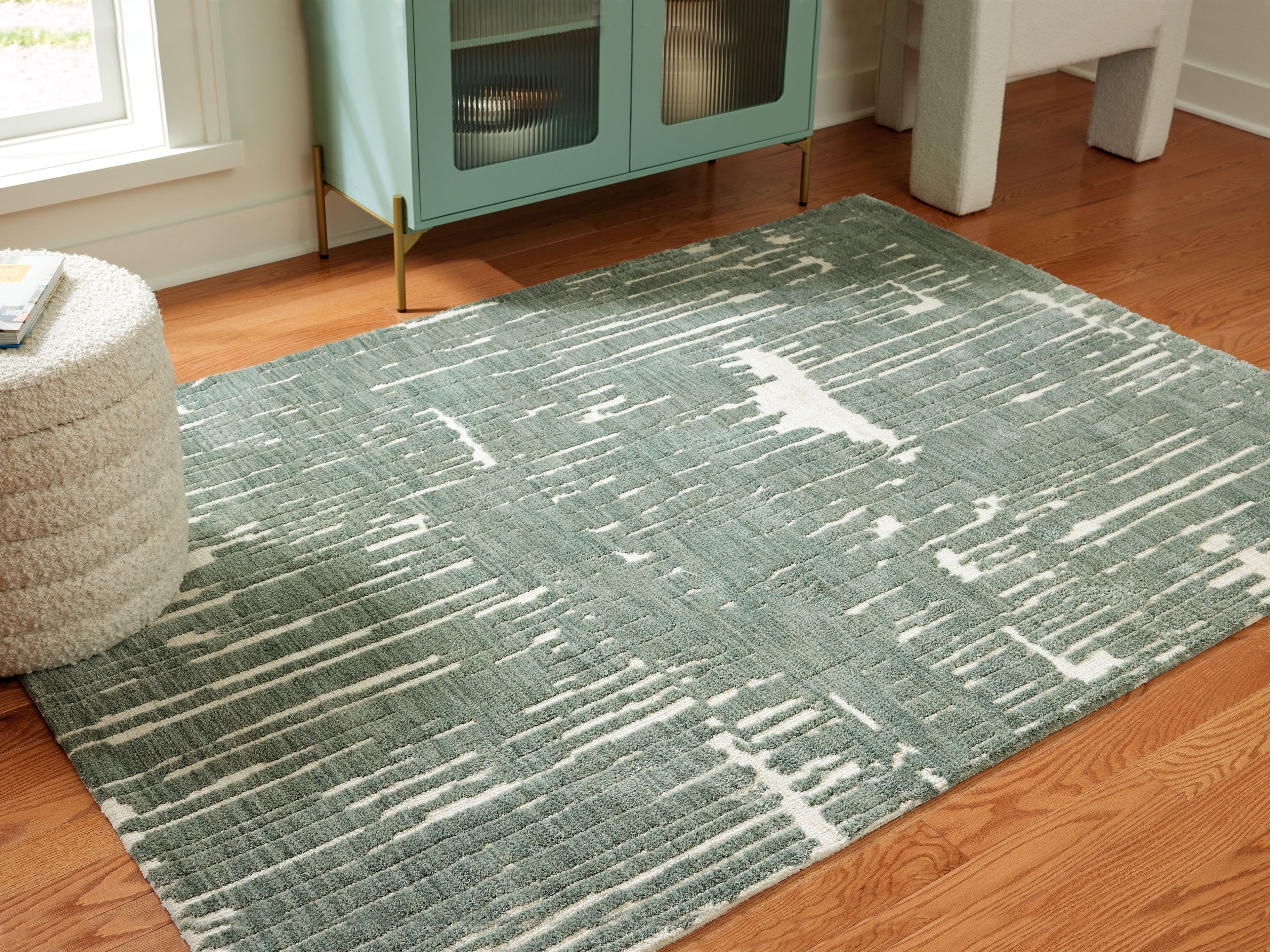 Light blue abstract area rug with distressed horizontal streaks, rectangular shape