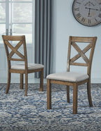 Dining chairs with X-back design and light seats, dark wood frames on patterned rug