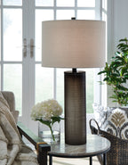 Glass table lamp with beige drum shade and dark brown ribbed glass column base