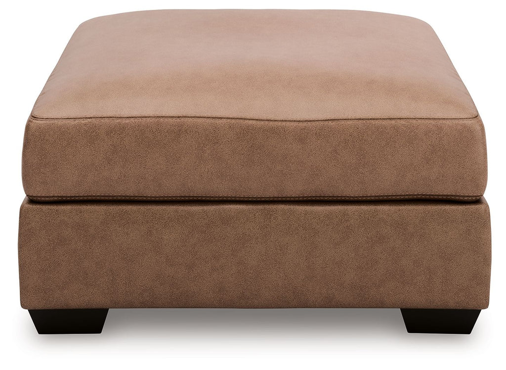 Oversized accent ottoman in tan upholstered fabric with low block legs