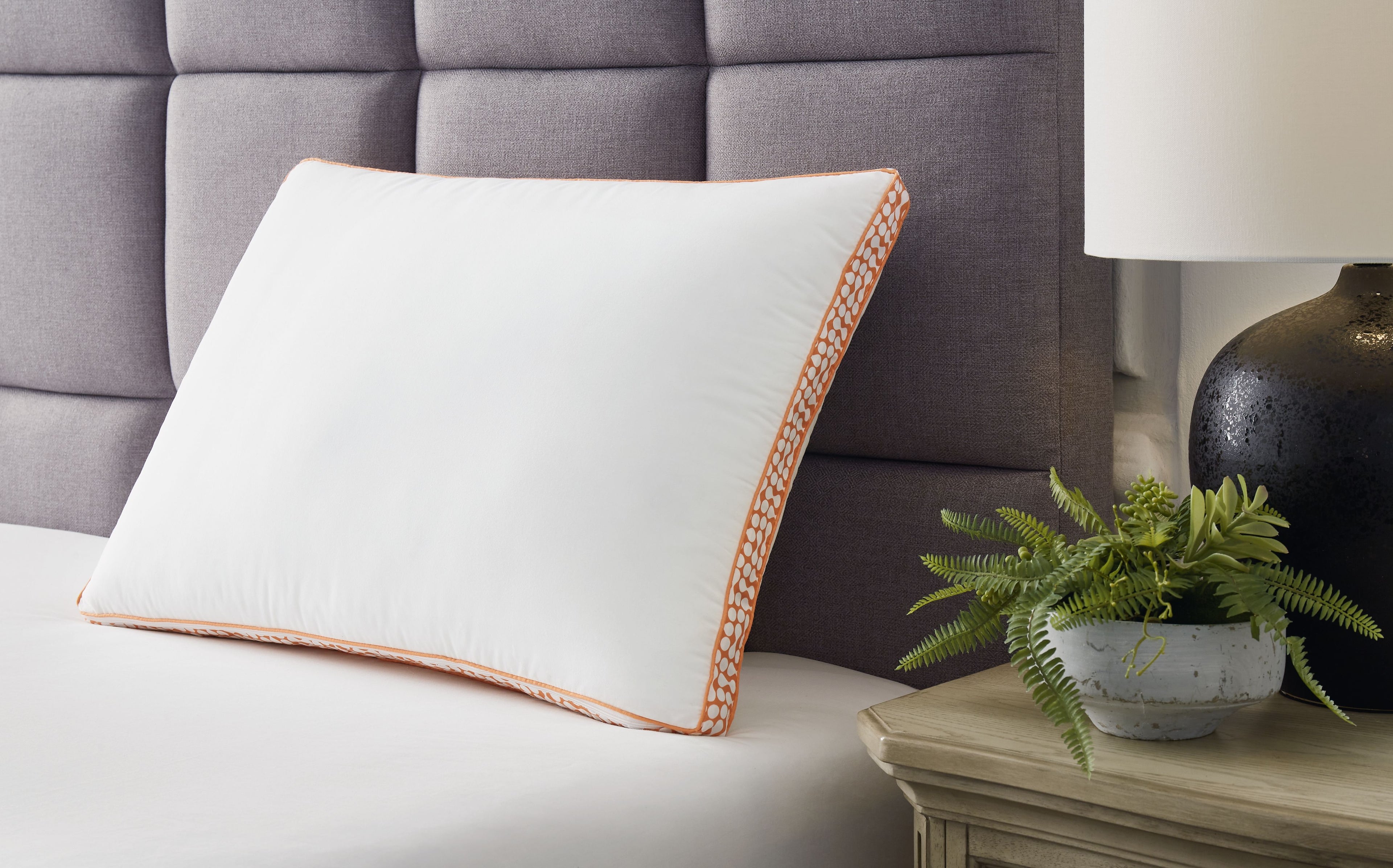 3-in-1 pillow with orange patterned border and thin piping