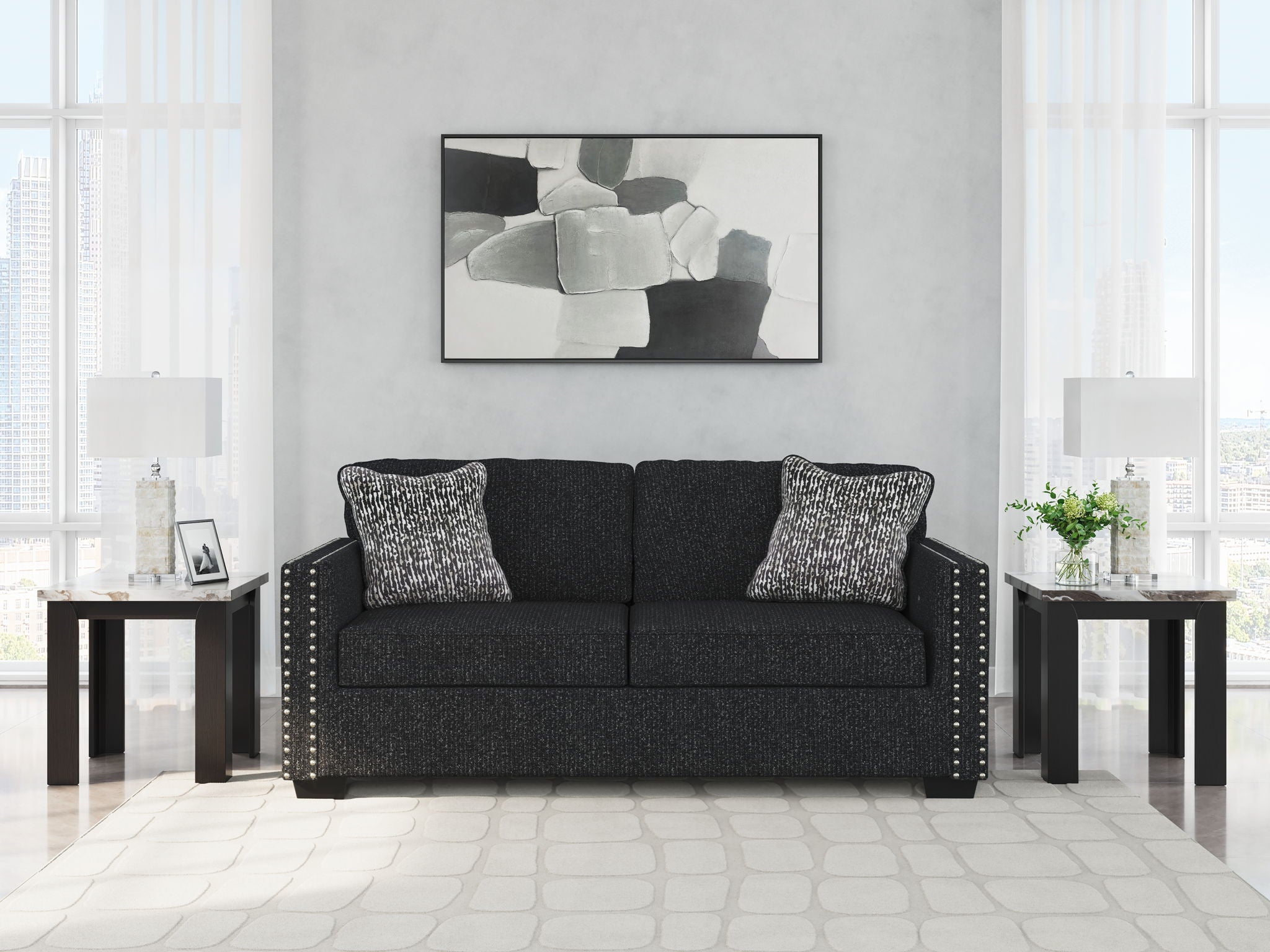 Coal fabric sofa with nailhead trim, three back cushions, and two heather gray pillows