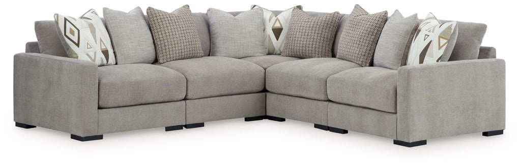 Gray sectional sofa with chaise corner and patterned throw pillows, side view