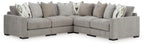 Gray sectional sofa with chaise corner and patterned throw pillows, side view