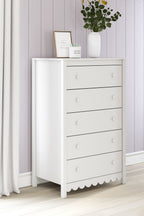 White five-drawer chest with scalloped base and round knob drawer pulls
