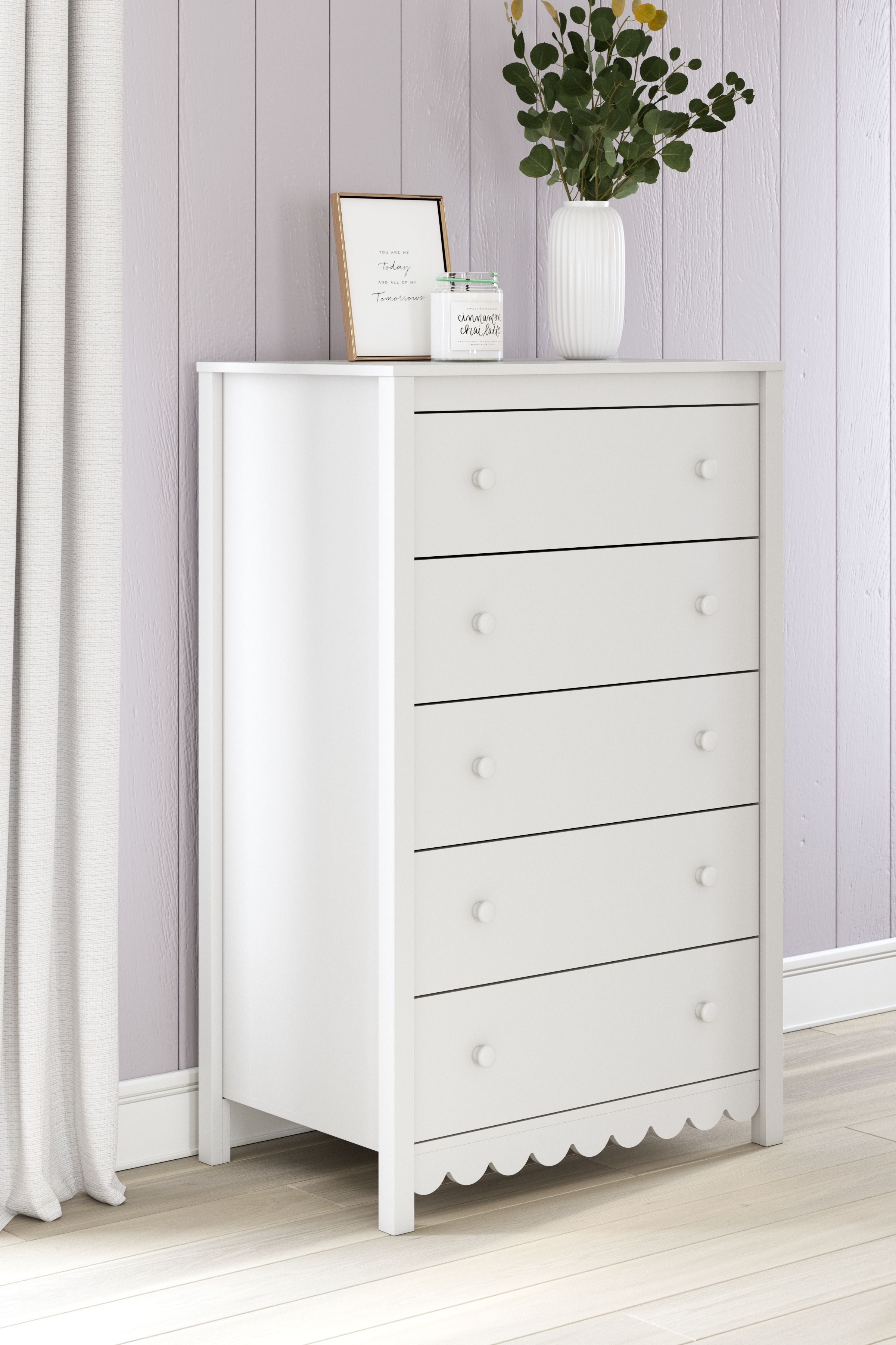 White five-drawer chest with scalloped base and round knob drawer pulls