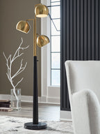 Gold floor lamp with three round shades, black pole, and round base