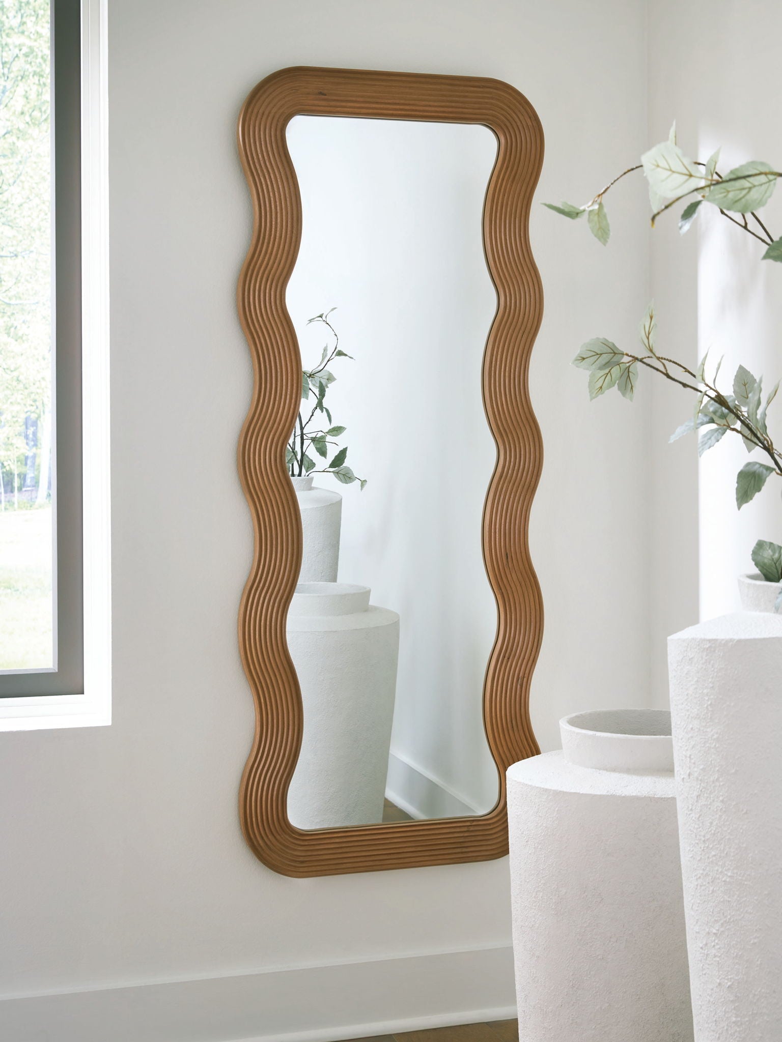 Brown floor mirror with wavy ribbed frame, rounded corners, vertical shape
