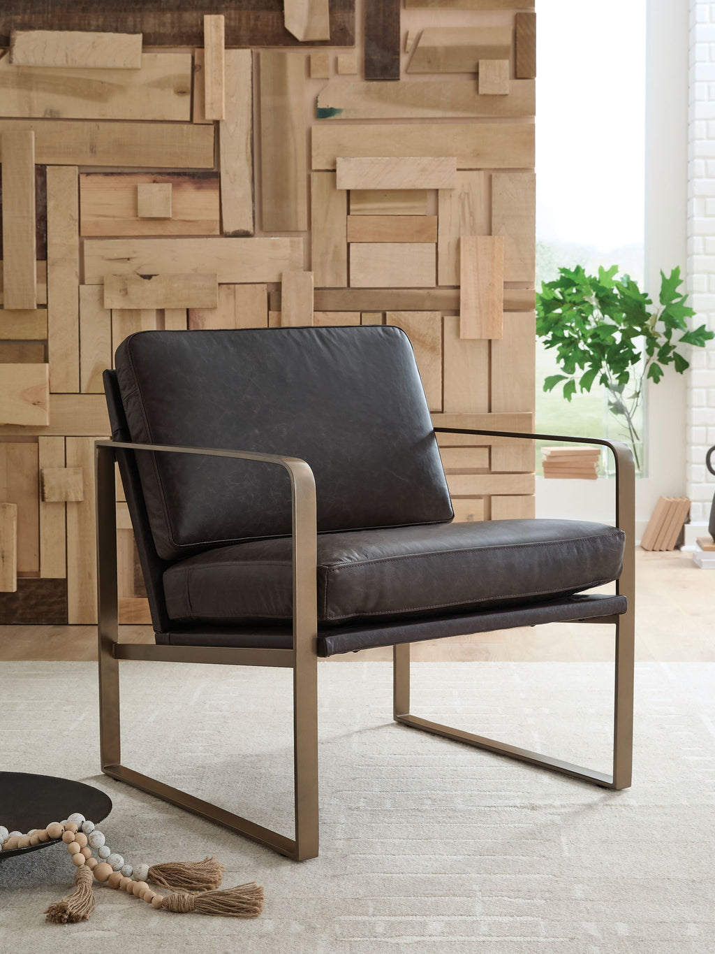 Dark brown accent chair with gold metal arms and wide padded backrest