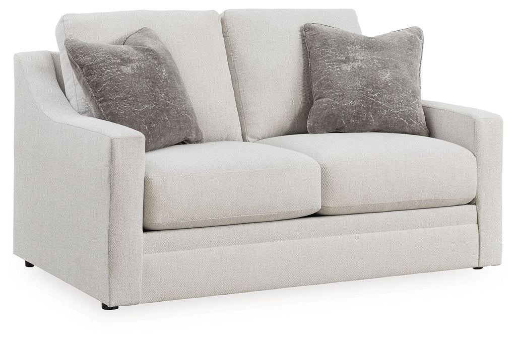 Chalk upholstered loveseat with two dark gray accent pillows and squared arms