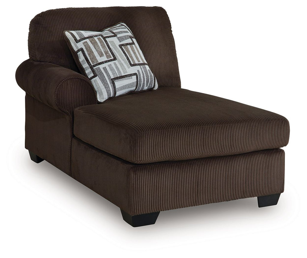 Chocolate-brown corner chaise with striped throw pillow and padded armrest