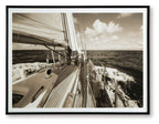 Sepia sailboat wall art print in a dark frame, deck and ocean view