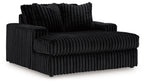 Oversized chaise with ribbed dark fabric, rolled armrests and thick seat cushion.